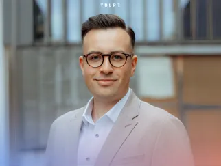 a man wearing glasses and a suit